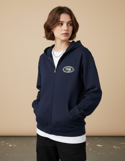 Model wearing the Taily Zip Hoodie in navy, featuring classic embroidered logo for timeless streetwear style.