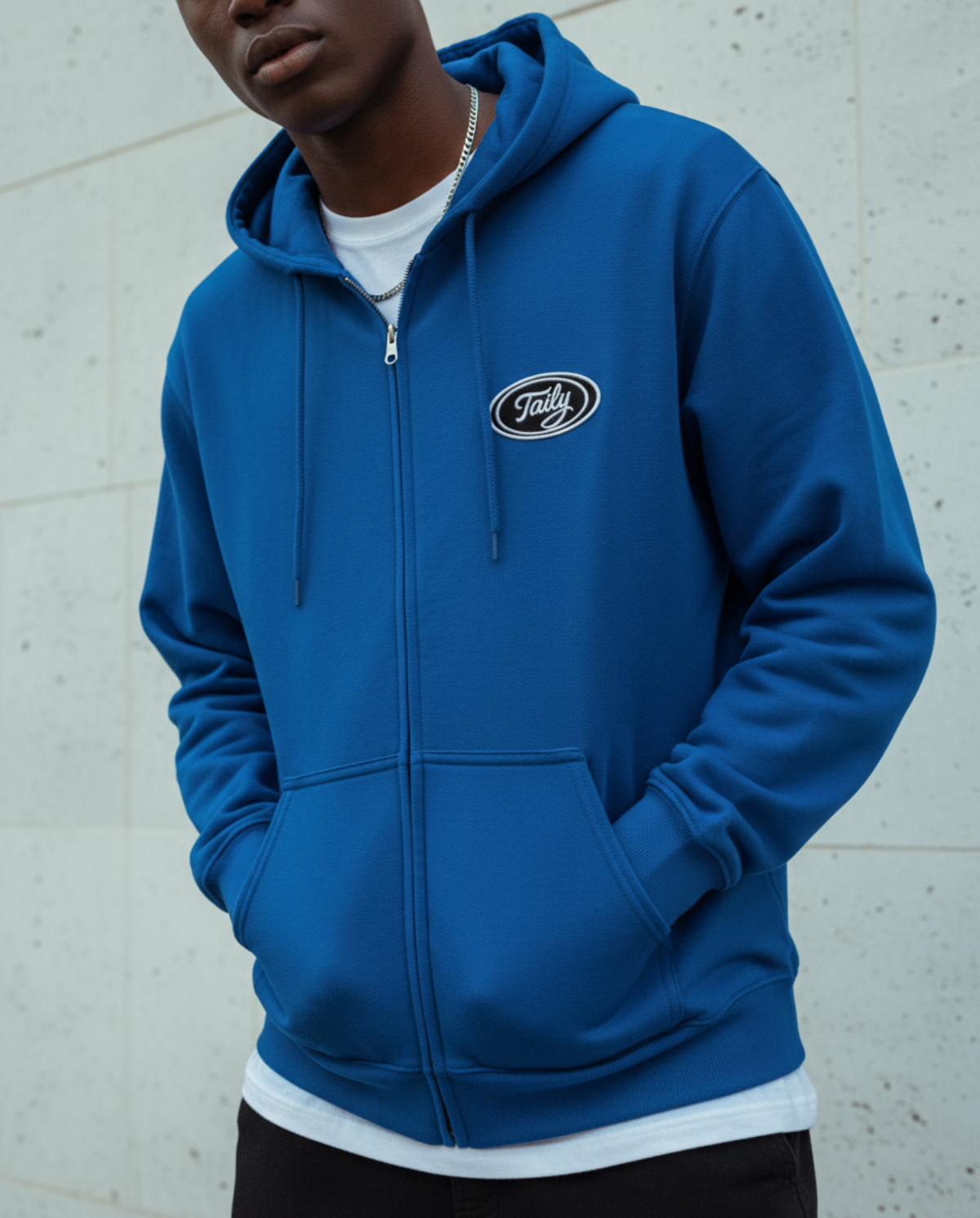 Taily Zip Hoodie in royal blue with embroidered logo, showcasing soft comfort and classic streetwear style.