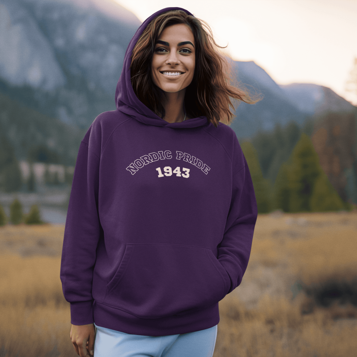 Relaxed fit Swedish Vallhund hoodie with "NORDIC PRIDE 1943" design worn by a smiling woman in nature.