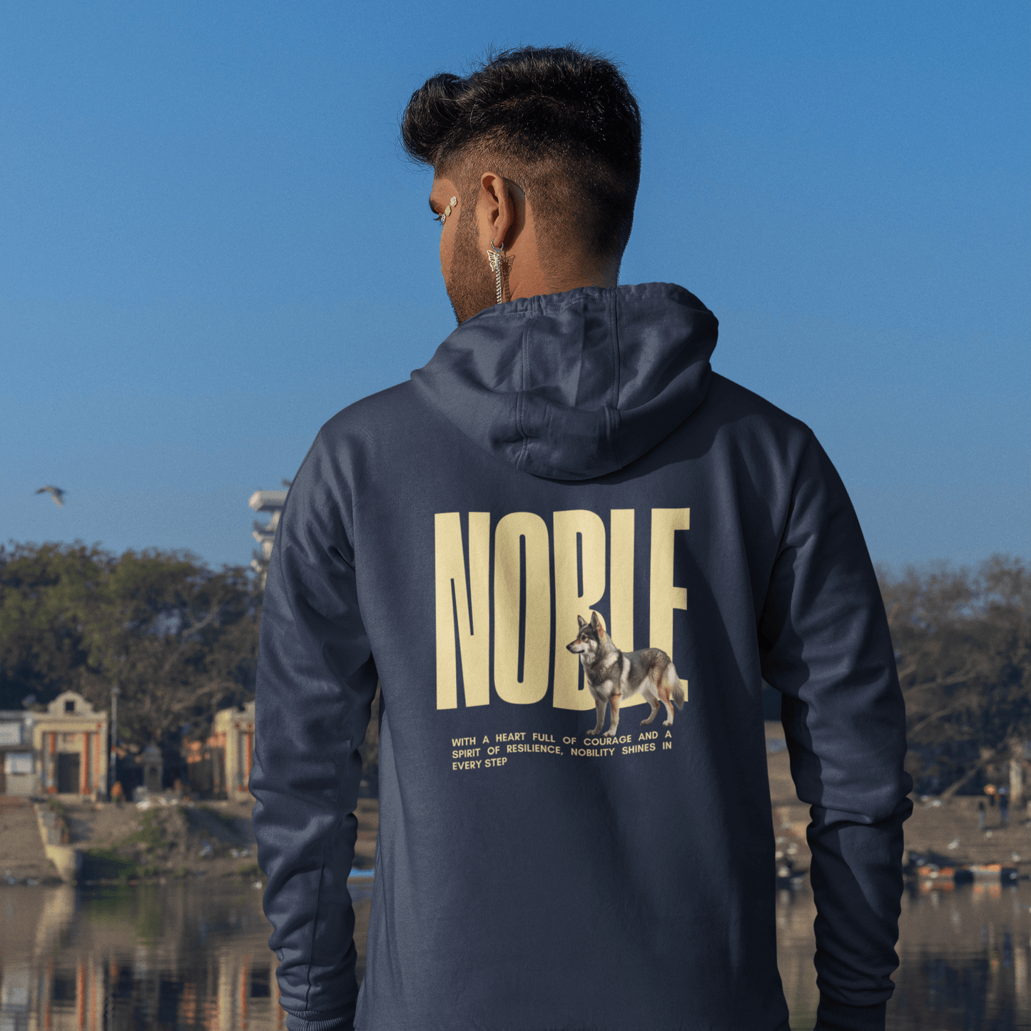 Man wearing a "NOBLE" hoodie with Swedish Vallhund design, showcasing relaxed fit and Nordic heritage.