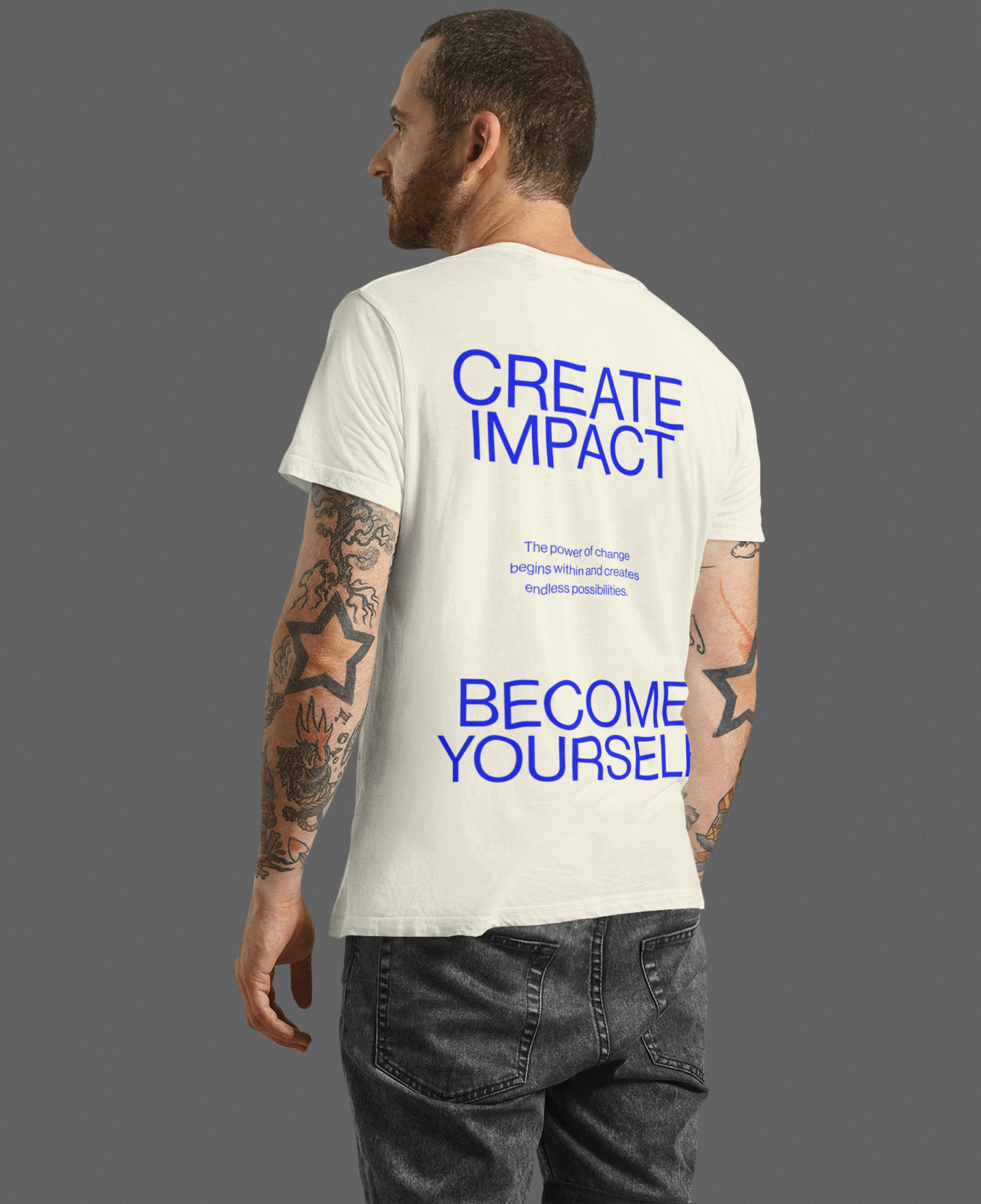 Man wearing Create Impact oversized tee with uplifting message on back, promoting inner growth and transformation.