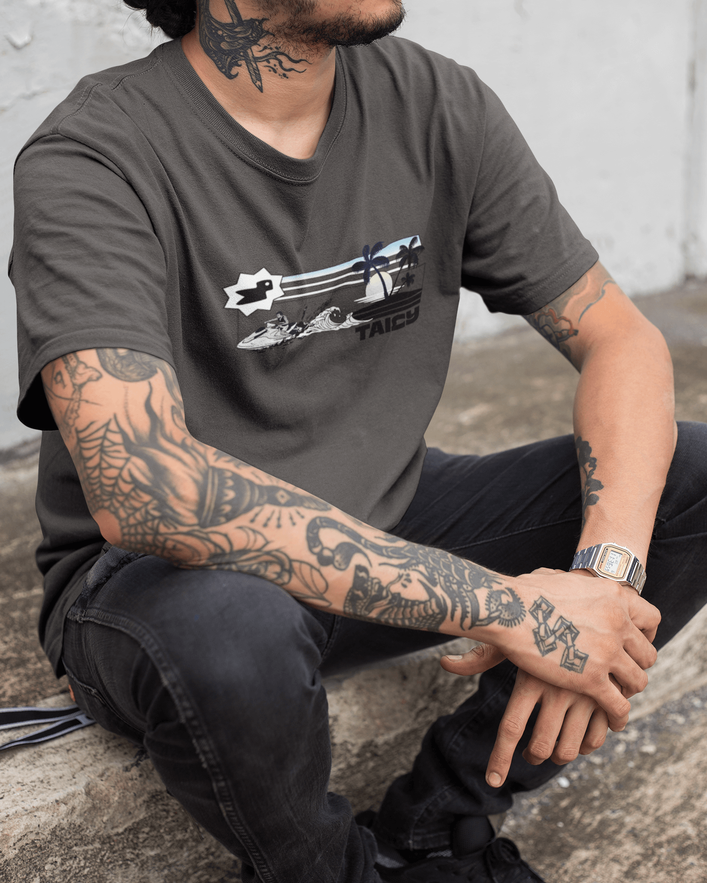 Man wearing Taily Summer Souvenir Tee with jet ski splash graphic and palm lines, showcasing summer style.