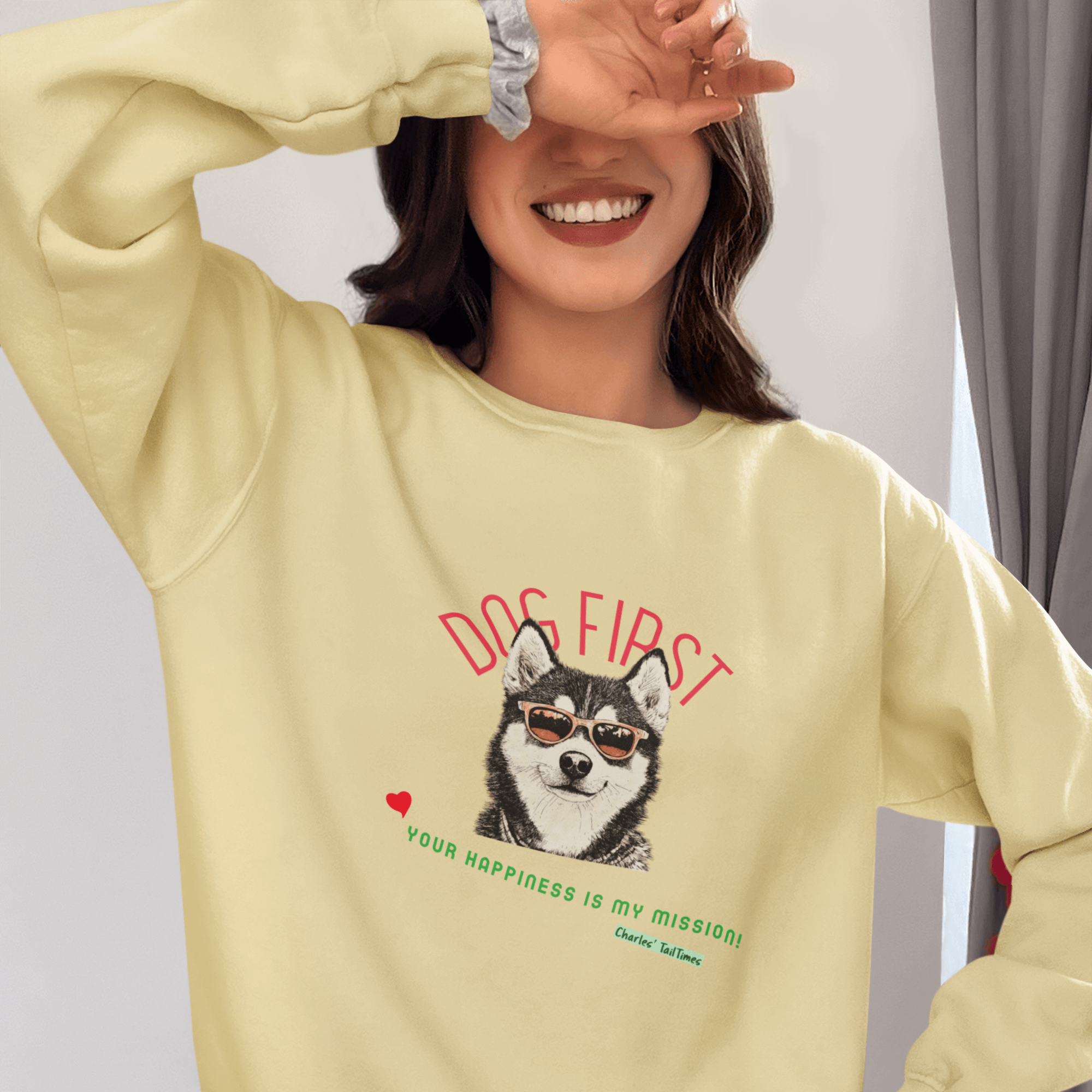 Smiling female model wearing a light yellow crewneck sweatshirt featuring an illustration of a Husky wearing sunglasses, with the text 