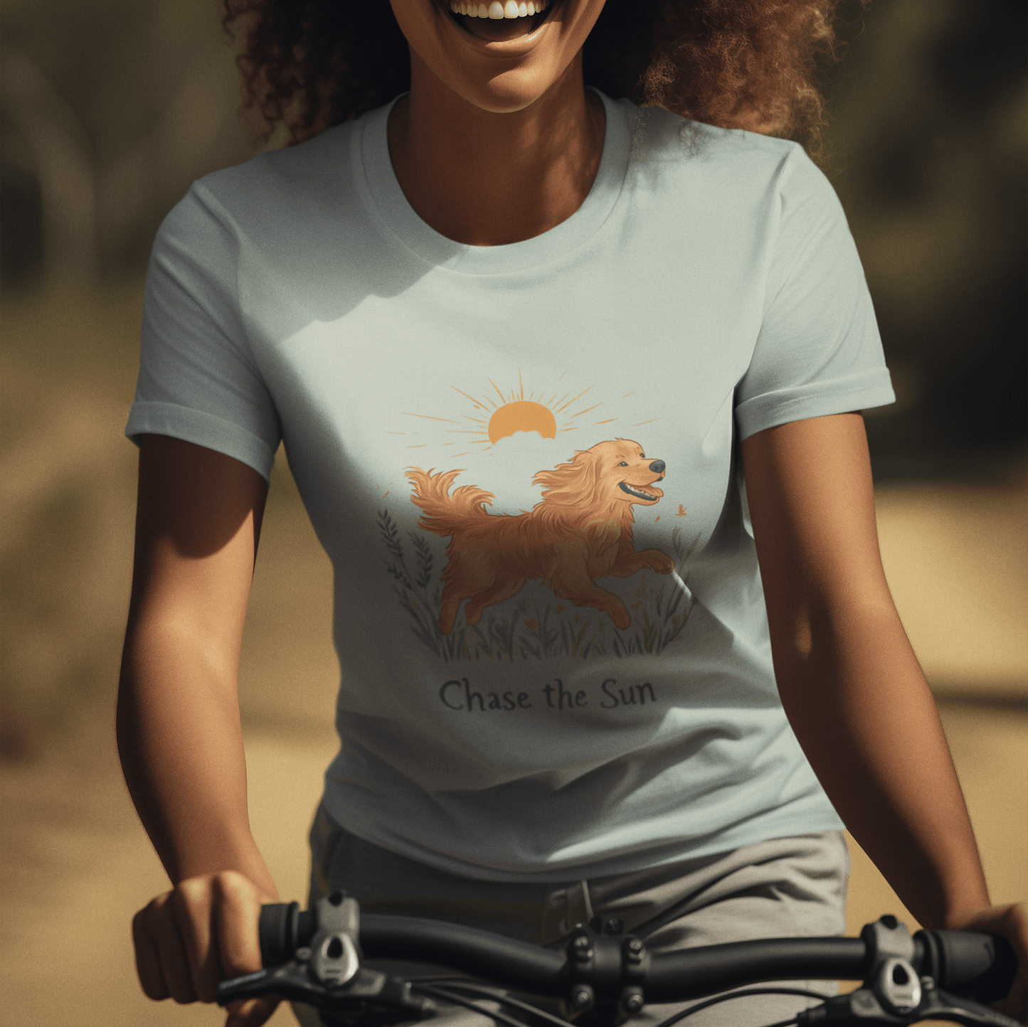 A woman wearing a "Chase the Sun" illustration T-shirt, riding a bike with a carefree smile under the sun, embodying a free and joyful lifestyle.