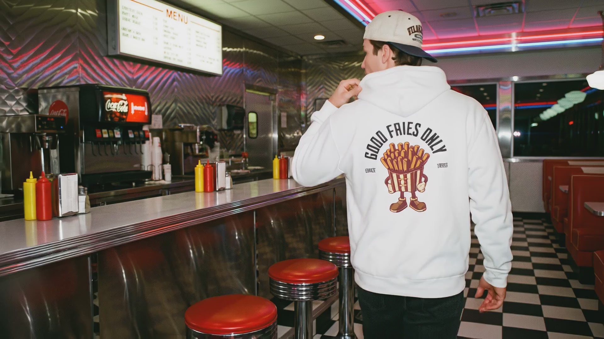 Load video: A quiet moment inside an American diner, showing a relaxed pause at a booth with warm lights, classic details, and a laid-back atmosphere from the Taily Diner collection.