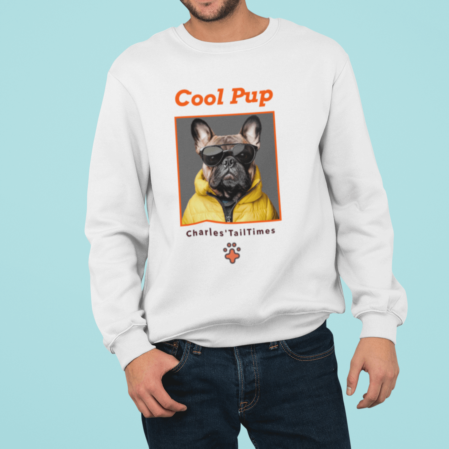 The image shows a young man wearing the "Cool Pup" sweatshirt with a French Bulldog dressed in a yellow jacket and sunglasses. The sweatshirt features the brand name "Charles' TailTimes." The background is a solid blue color.