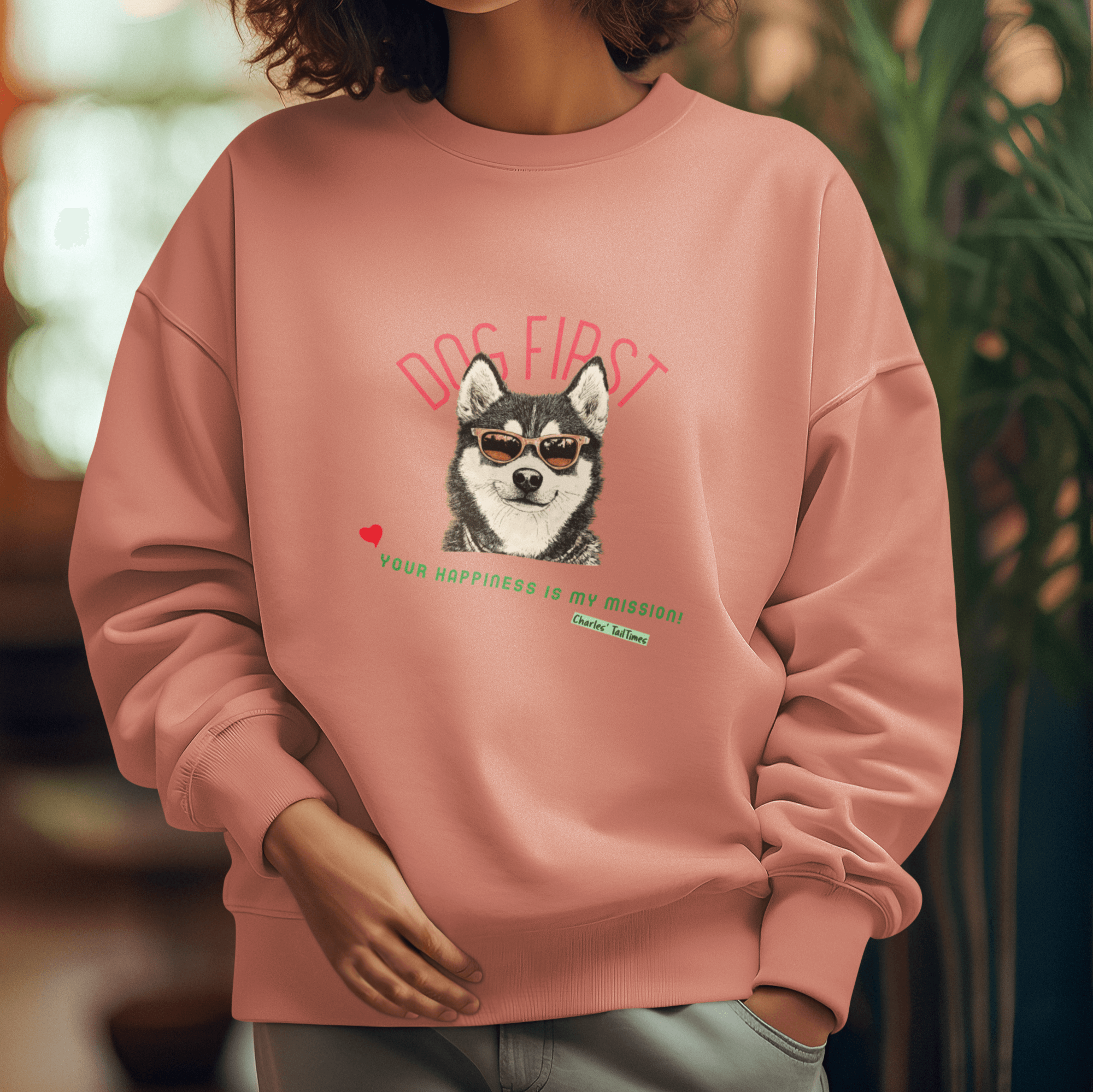 Young female model wearing a pink crewneck sweatshirt featuring an illustration of a Husky wearing sunglasses, with the text 