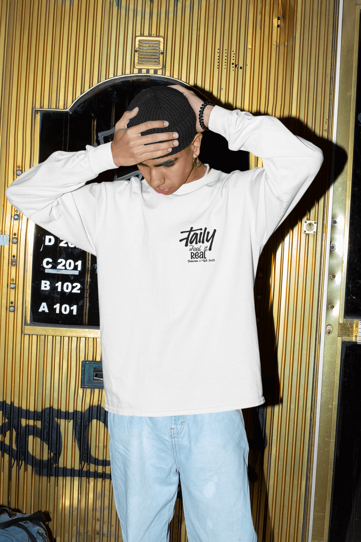 Taily Feel It Real sweatshirt in white, featuring a chest logo and casual street style design.