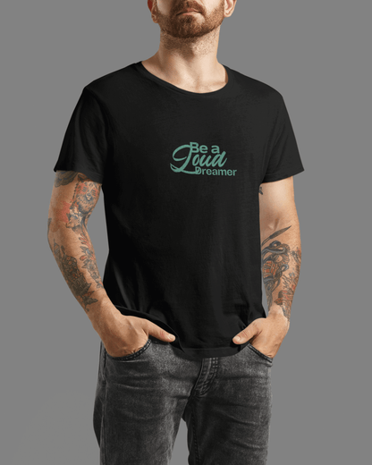 Men's black 'Be a Loud Dreamer' tee with minimal script design on soft cotton fabric.