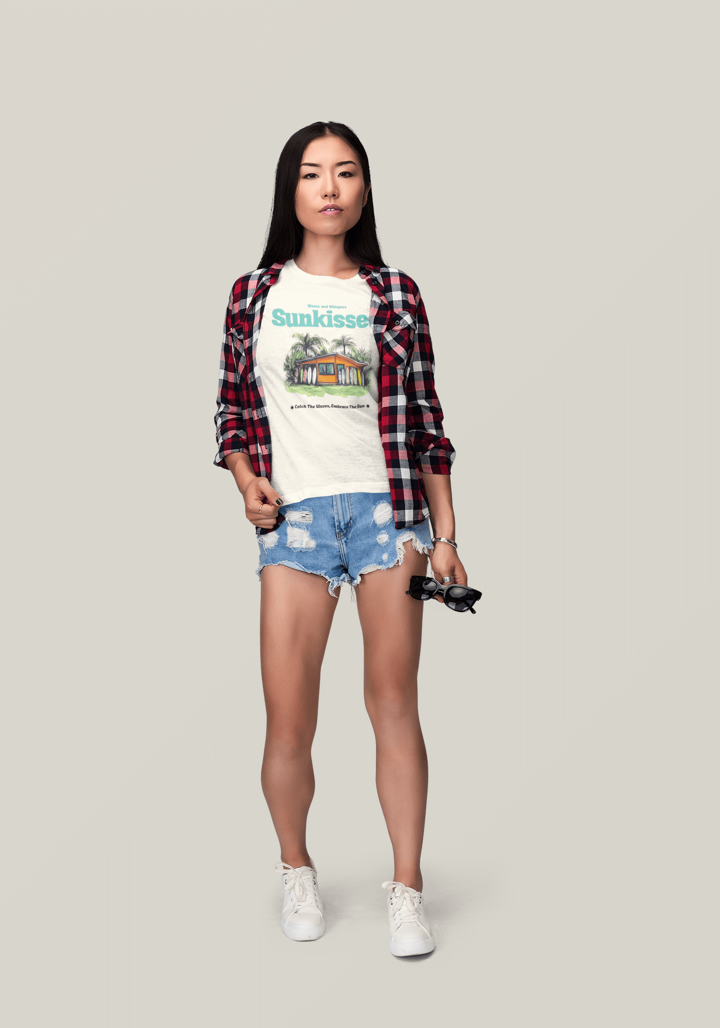 Model wearing Sunkissed Surf Shack T-Shirt with plaid shirt and denim shorts, embodying beach vibes and summer adventures.