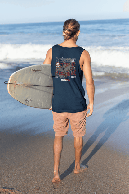 Man wearing Taily Scorpion Graphic Tank while holding a surfboard on the beach, showcasing a navy red print.