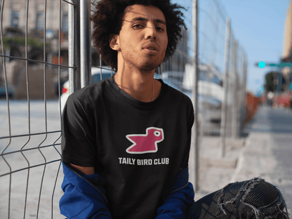 Model wearing Taily Bird Club black boxy t-shirt with pink bird print, showcasing streetwear style and modern fit.