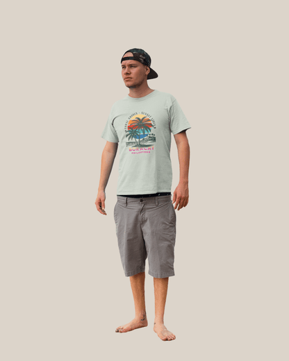 A man wearing a Boracay Sunset Vibes T-shirt and shorts, embodying tropical beach vibes and summer spirit.